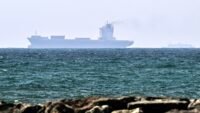 Vessels off the coast of Sharjah, UAE, symbolizing global oil trade and supply routes.
