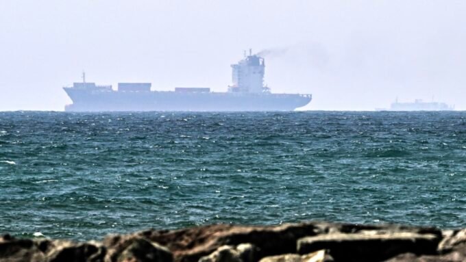 Vessels off the coast of Sharjah, UAE, symbolizing global oil trade and supply routes.