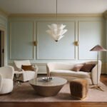Laura Harrier and Tiffany Howell's cinematic furniture collection for Crate & Barrel, featuring a stylish living room setup.