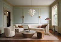 Laura Harrier and Tiffany Howell's cinematic furniture collection for Crate & Barrel, featuring a stylish living room setup.