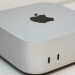 A sleek, compact Apple Mac Mini desktop computer, representing the latest model with enhanced AI capabilities.