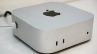 A sleek, compact Apple Mac Mini desktop computer, representing the latest model with enhanced AI capabilities.