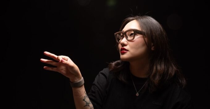 A person wearing Meta Ray-Ban Display smart glasses, interacting with virtual elements in their field of vision.