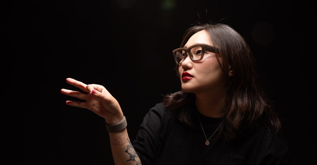 A person wearing Meta Ray-Ban Display smart glasses, interacting with virtual elements in their field of vision.