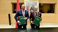 Bank Al-Maghrib Governor Abdellatif Jouahri and Minister Ahmed El Bouari signing a financial education partnership agreement in Rabat.