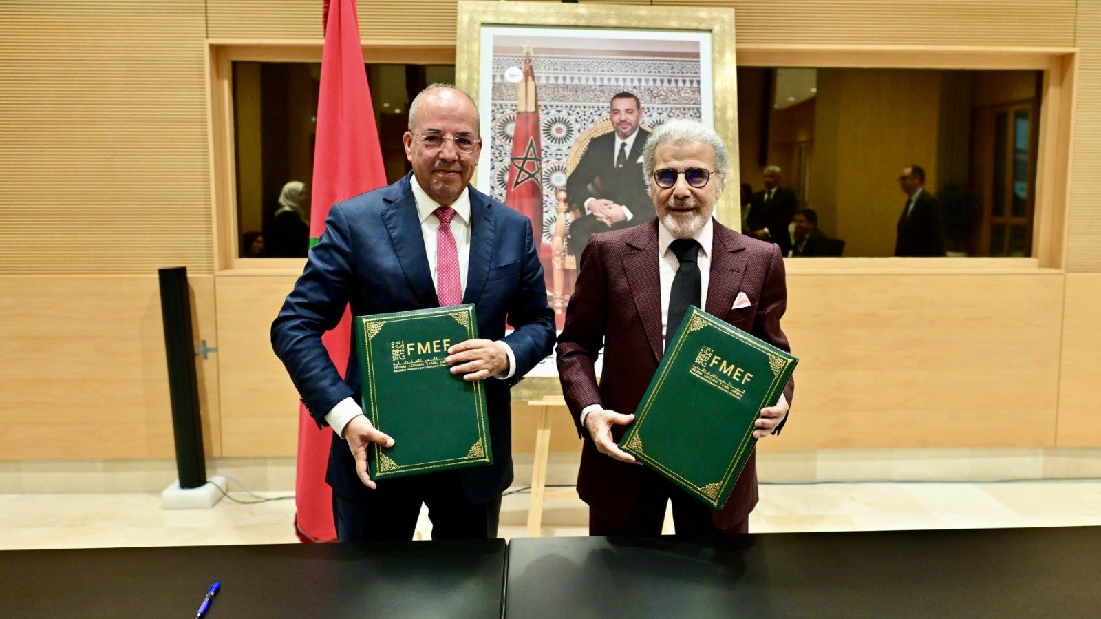 Bank Al-Maghrib Governor Abdellatif Jouahri and Minister Ahmed El Bouari signing a financial education partnership agreement in Rabat.
