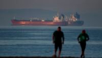 Liberia-flagged crude oil tanker Shenlong Suezmax docked at Mumbai Port after navigating the Strait of Hormuz amidst West Asia conflict.