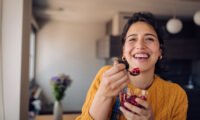 Fresh pomegranates cut open, showing their vibrant red arils, symbolizing heart-healthy benefits.