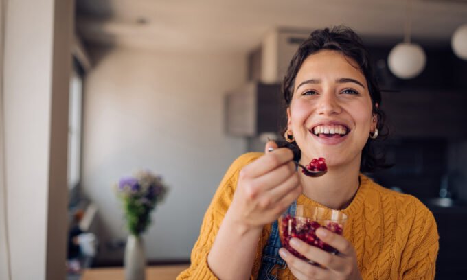 Fresh pomegranates cut open, showing their vibrant red arils, symbolizing heart-healthy benefits.