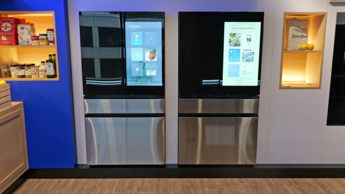 A modern Samsung Bespoke refrigerator with a large touchscreen display showing various smart features and food recognition.