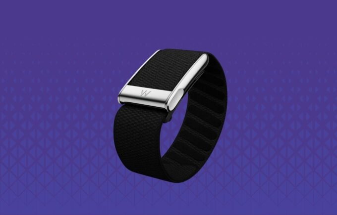 A collection of modern screenless fitness trackers, including a Whoop band, Oura ring, and Fitbit Air device, symbolizing the trend towards discreet wearable technology.