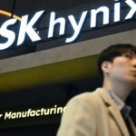 The SK Hynix logo displayed on a glass wall, symbolizing the company's trillion-dollar market valuation driven by the booming AI chip industry.