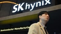 The SK Hynix logo displayed on a glass wall, symbolizing the company's trillion-dollar market valuation driven by the booming AI chip industry.