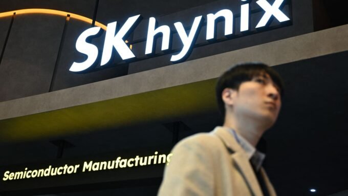 The SK Hynix logo displayed on a glass wall, symbolizing the company's trillion-dollar market valuation driven by the booming AI chip industry.