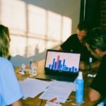 A diverse group of small business owners reviewing insurance documents with a professional advisor, highlighting tailored coverage.
