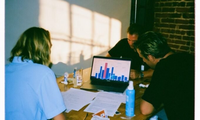 A diverse group of small business owners reviewing insurance documents with a professional advisor, highlighting tailored coverage.