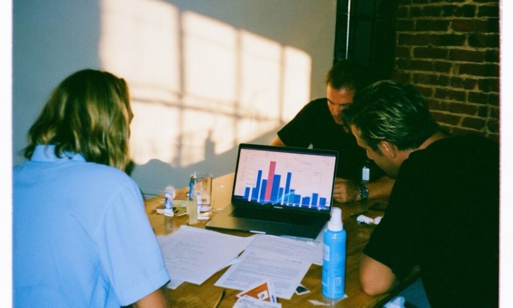 A diverse group of small business owners reviewing insurance documents with a professional advisor, highlighting tailored coverage.