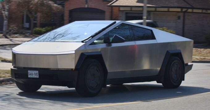 A Tesla Cybertruck on a road with one of its wheels highlighted, symbolizing the recall issue.