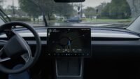 Tesla vehicle displaying Full Self-Driving (FSD) interface on its central screen, with a cityscape of China in the background.