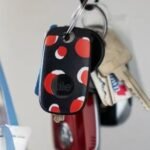 Black and white Tile Pro trackers displayed, highlighting their sleek design and keyring hole.