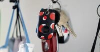 Black and white Tile Pro trackers displayed, highlighting their sleek design and keyring hole.