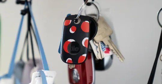 Black and white Tile Pro trackers displayed, highlighting their sleek design and keyring hole.
