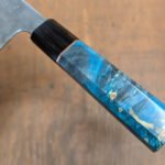 A beautifully crafted Wa-style octagonal knife handle made from two contrasting woods, showcasing the intricate joinery and smooth finish.
