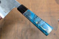 A beautifully crafted Wa-style octagonal knife handle made from two contrasting woods, showcasing the intricate joinery and smooth finish.