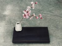 A finished Yakisugi display stand showcasing charred cedar wood grain