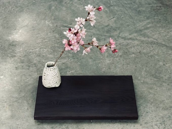 A finished Yakisugi display stand showcasing charred cedar wood grain