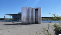 A 22-foot-tall pavilion made of undulating aluminum extrusions, replicating the iconic Aalto vase, standing on Copenhagen's harbor waterfront during 3daysofdesign.