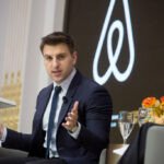 Airbnb CEO Brian Chesky on stage, discussing innovation and technology.