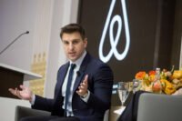 Airbnb CEO Brian Chesky on stage, discussing innovation and technology.