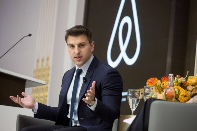 Airbnb CEO Brian Chesky on stage, discussing innovation and technology.
