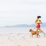 A steaming cup of coffee next to running shoes and fitness equipment, symbolizing pre-workout energy and athletic performance.