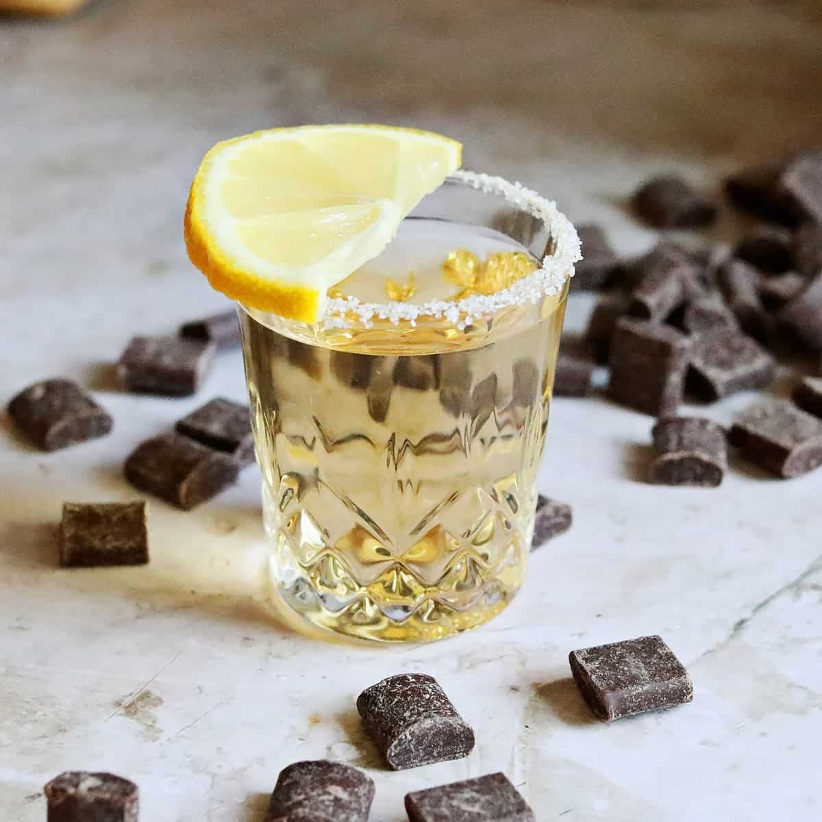 A perfectly prepared Chocolate Cake Shot with a sugared lemon wedge on the rim.