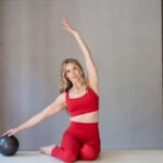 Kristin McGee, a registered yoga teacher and personal trainer, with a mindbodygreen creatine supplement.