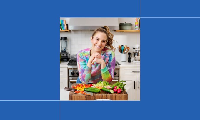 Melissa Ben-Ishay smiling in a kitchen, holding a plate of a freshly prepared, simple weeknight meal.