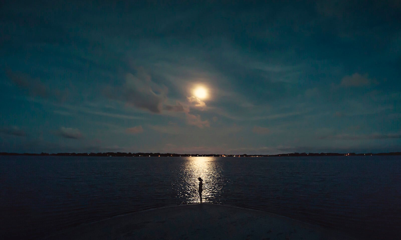 A luminous full moon shining brightly in a night sky, symbolizing culmination and new beginnings, with a subtle hint of the Capricorn seagoat.