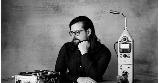 Experimental musician and YouTuber Hainbach in his studio, surrounded by unique synthesis equipment.