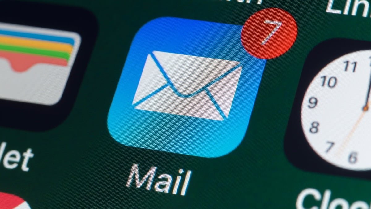 Apple's 'Hide My Email' Under Threat: Why Your Privacy Needs New Allies 3 A person's hand holding an iPhone with a blurred background, symbolizing digital privacy and email protection.
