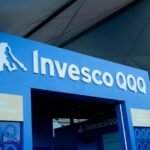 Invesco logo alongside digital assets and blockchain imagery, representing their new tokenized stablecoin reserve fund.