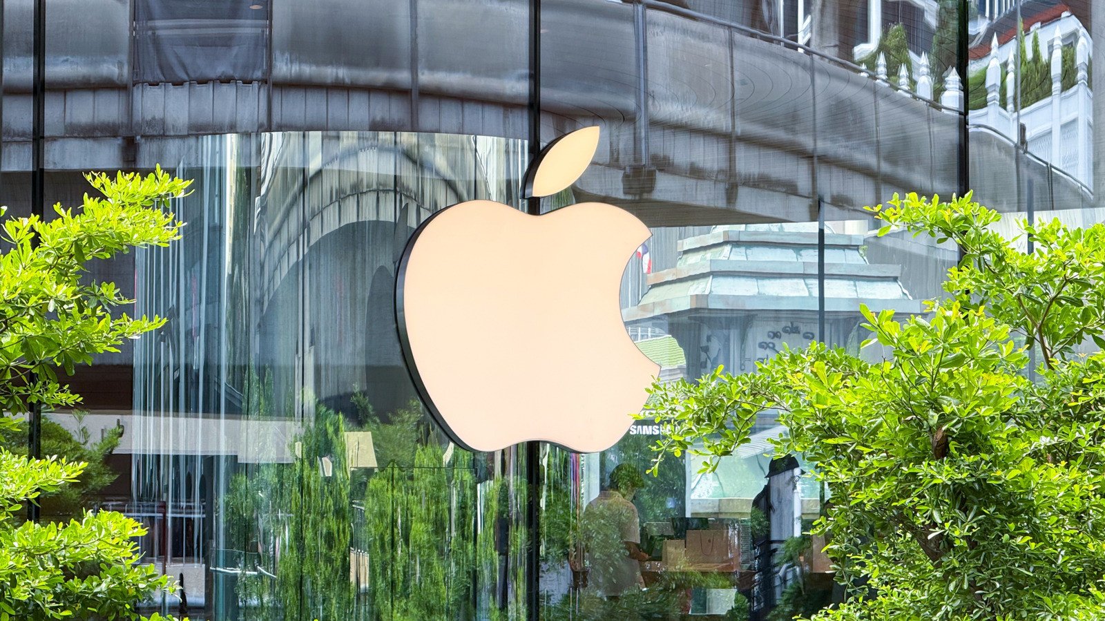 A stylized image representing data flowing out of a smartphone or a factory, with Apple and Tata Electronics logos subtly integrated.