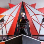 Global Call to Creators: Showcase Your Innovations at Fall Maker Faires 2026! 8 Diverse makers showcasing innovative projects at a bustling Maker Faire event, with various technologies and crafts on display.