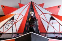 Diverse makers showcasing innovative projects at a bustling Maker Faire event, with various technologies and crafts on display.