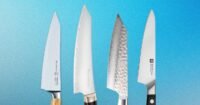 A selection of high-quality mid-sized kitchen knives, including Messermeister and Zwilling models, arranged on a wooden cutting board.