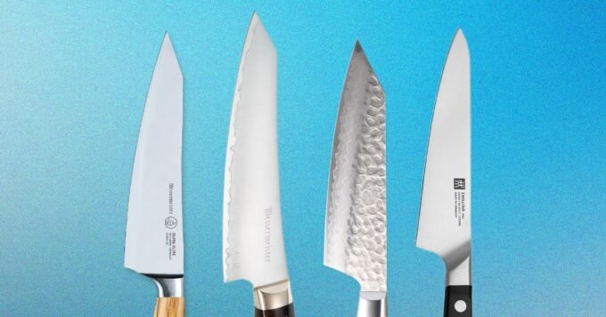 A selection of high-quality mid-sized kitchen knives, including Messermeister and Zwilling models, arranged on a wooden cutting board.