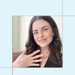 An Oura Ring 4 in gold on a finger, illustrating its sleek design and wearability.