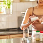 Woman contemplating health and wellness, symbolizing the impact of nutrition on ovarian aging and menopause.