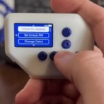 The PolyCast5 multitool device displaying its AI Packet Monitor function on a color screen.